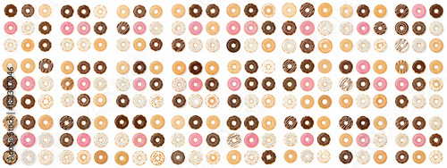 Seamless pattern of colorful vector donuts with various chocolate, pink, sprinkle, and plain glazes on a bright white background.