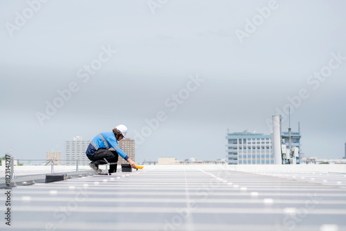 Engineer inspection solar panel installation on rooftop, checking photovoltaic system for energy efficiency, renewable energy performance and maintenance, technician checking renewable technology.