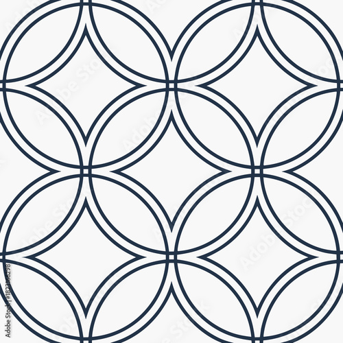 Seamless geometric pattern featuring interlocking dark blue circles forming diamond shapes on a clean white background representing modern and classic design motifs