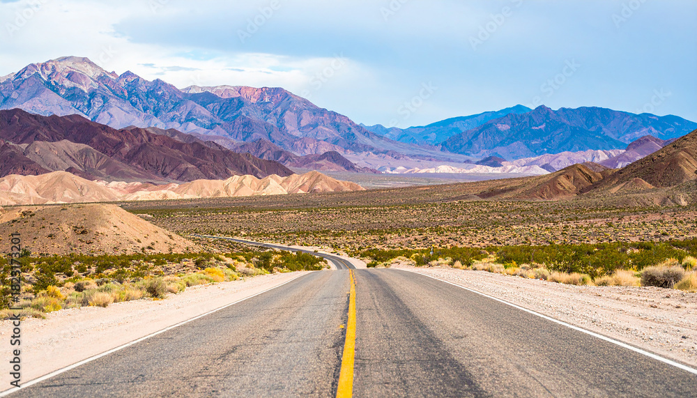 Fototapeta premium Long road through desert, empty street leading into the mountains, two lanes asphalt route