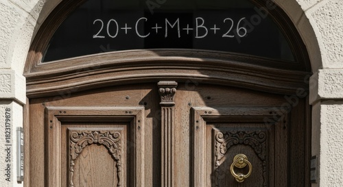 Epiphany chalk inscription 20+c+m+b+26 on a wooden door, blessing for the new year.