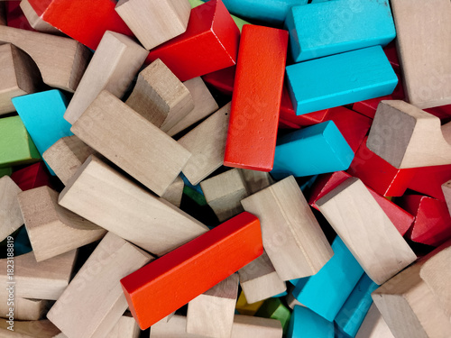 Background texture of mixed colored wooden building blocks for children development concept.