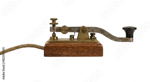 Vintage morse code telegraph key, an old historical communication device on isolated background.