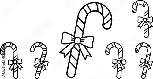 Three candy canes with red ribbons isolated on white background