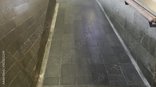 Empty ramp with metal railings for handicapped people near public building entrance . Tilt-up movement with a hand-held.
