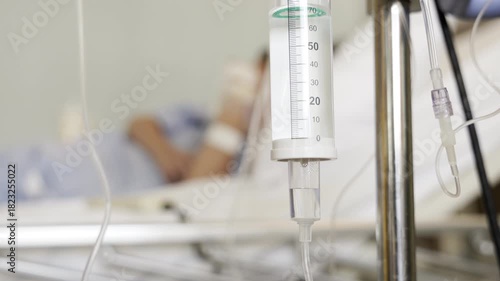intravenous drip with blur kid patient on bed background. iv drips of medical fluid treatment.