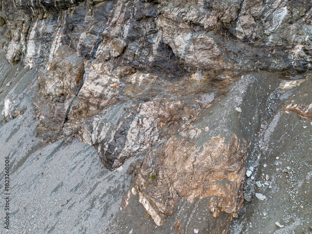 Naklejka premium Rugged Rock Cliff Texture With Layered Strata and Weathered Stone Surface