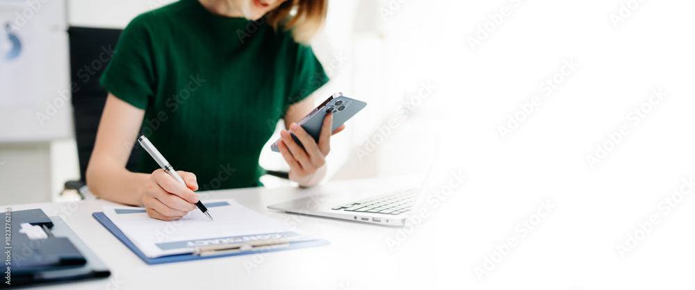 Obraz premium Businesswoman hand working digital marketing media in virtual screen with mobile phone and modern compute with VR icon diagram at office