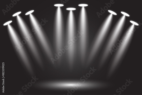 Stage lighting spotlights shining down on a dark background
