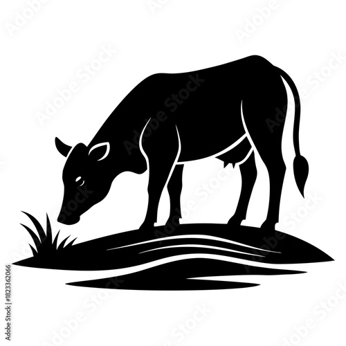 Black silhouette of a cow grazing on a grassy hill silhouette