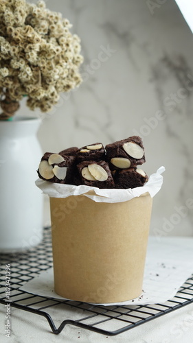 Selective focus pieces almond brownies on cooling rack, white background