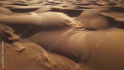 Top-down aerial view of subtle tan and brown layered sand dunes subtly vibrating and shifting in resonant patterns across a vast desert motion, organic, environmental