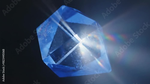 Slow motion close-up of a rotating vibrant blue crystalline geometric structure shifting and strongly refracting intense spectral light rays precious, complexity, futuristic