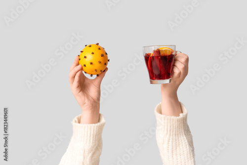 Female hands holding orange...