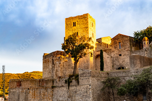 Fototapeta Naklejka Na Ścianę i Meble -  Sunset view of colourful Collioure, narrow streets and yellow, pink, orange houses, summer vacation destination town with historical buidings and beaches, Pyrenees-Orientales, France