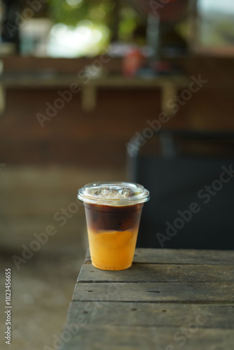 holding a cup of black coffee orange