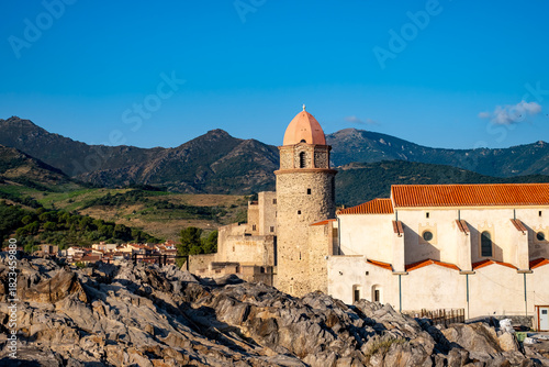 Fototapeta Naklejka Na Ścianę i Meble -  View of colourful Collioure, narrow streets and yellow, pink, orange houses, summer vacation destination town with historical buidings and beaches, Pyrenees-Orientales, France