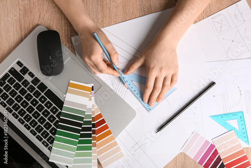 Young female designer worki...