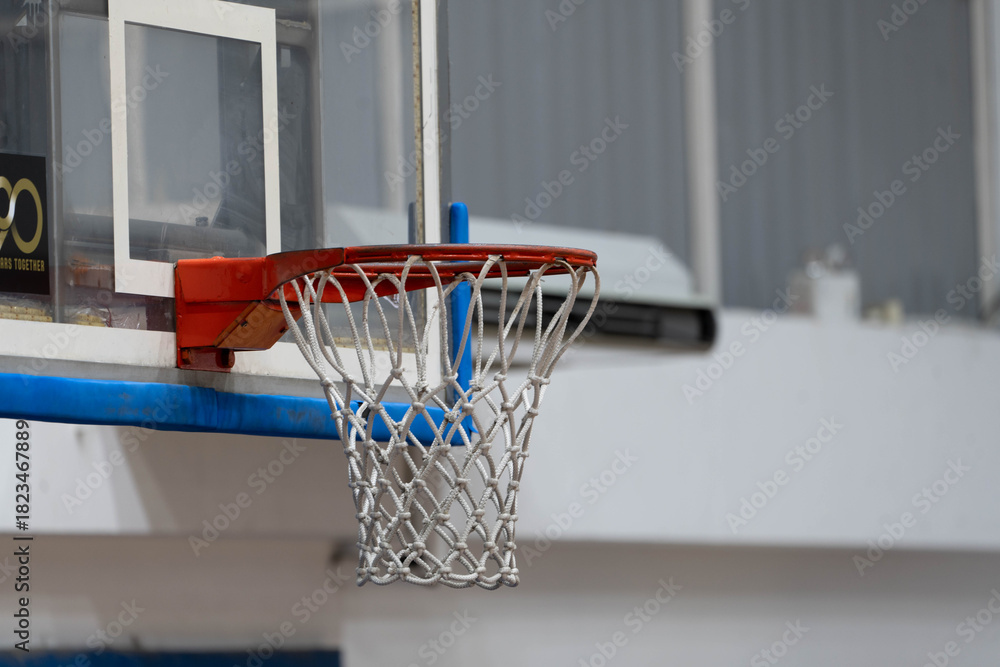 Fototapeta premium A close up of a basketball hoop with a red rim and a white net