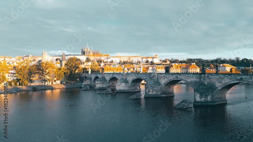 Discover the stunning views of Charles Bridge and Prague Castle as morning light illuminates the city. Experience the tranquil beauty over the Vltava River.