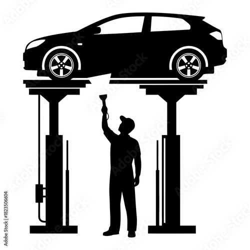 Car mechanic working under vehicle on lift, professional auto repair service garage job