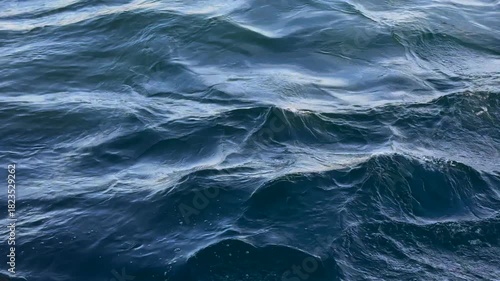 Sea waves, slow motion.
Blue seawater and gentle waves on the surface.
Breeze on the sea.
Calm waves and aquamarine sea breeze.