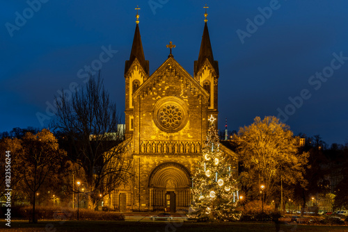 Illuminated Christmas Tree in Karlín, Prague, with the Church of St Cyril and Methodius During Winter Holiday Evening
