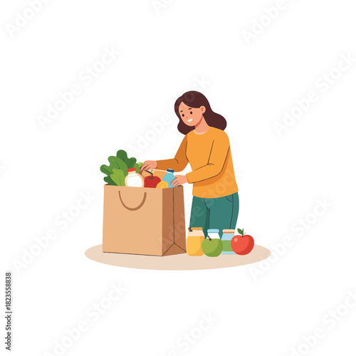 Woman organizing groceries into brown paper bag after a shopping trip in kitchen
