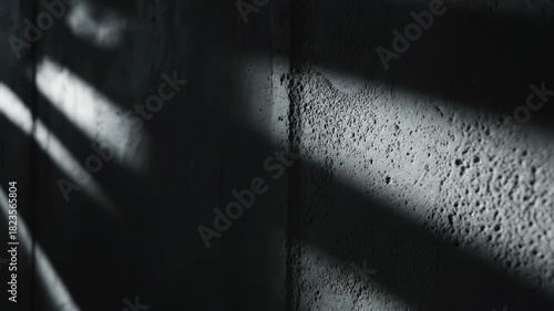 Ultra slow motion cinematic shot of long, dark shadows systematically moving and shifting across a textured, perfectly blank concrete wall surface rhythm, ultraslowmotion, contrast