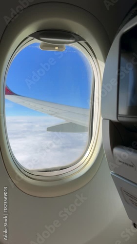 A plane flying through the clouds.
A view of clouds at high altitude from an airplane.
A passenger plane in flight.
Air transport and tourism.
Window, sky, aviation, airport, aircraft, tour tourism, c
