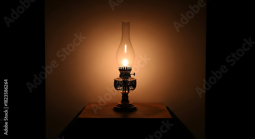 A vintage kerosene oil lamp glowing brightly with a warm flame in a dark, moody setting