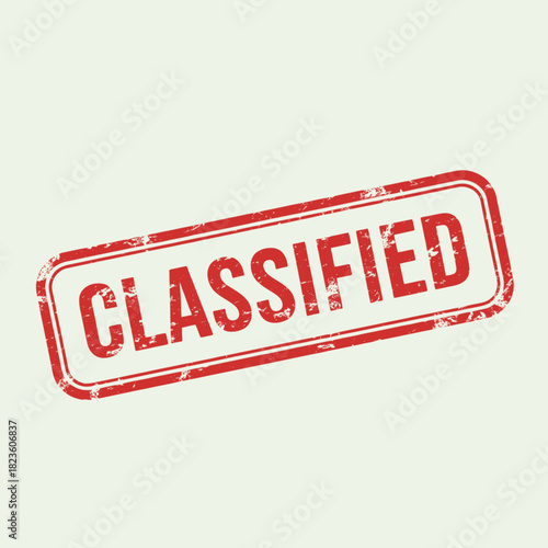 A red grunge rubber stamp with the word "CLASSIFIED" in bold uppercase letters on a light background, indicating restricted information.