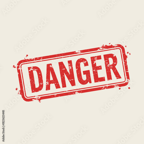 A weathered red rubber stamp imprint with the word DANGER in bold, uppercase letters on a light background.