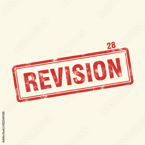 Red revision stamp on beige background with number 28.