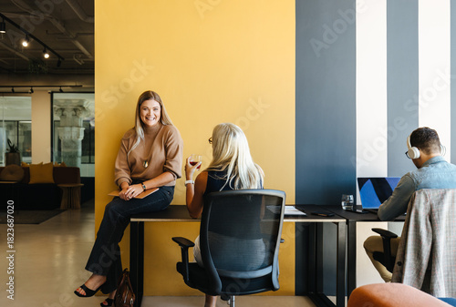 Team discussing ideas in a modern open workspace with stylish decor