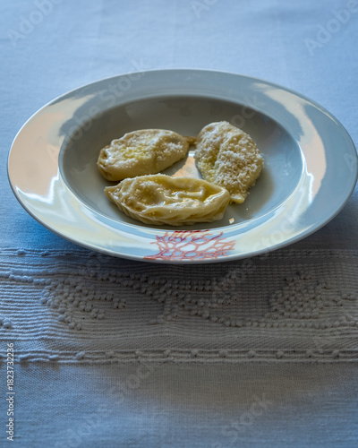 Homemade traditional Sardinian pasta called Culurgiones on a porcelain plate
