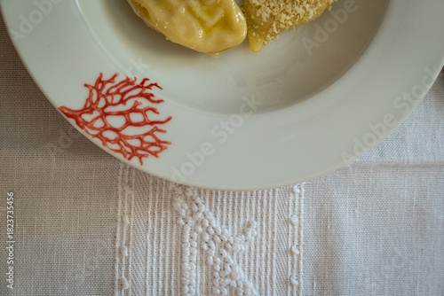 Homemade traditional Sardinian pasta called Culurgiones on a porcelain plate