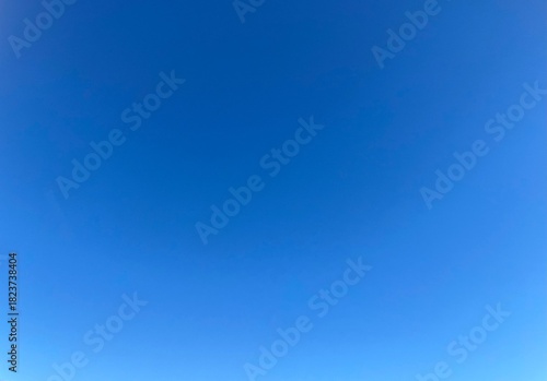 Raw unedited Spanish Iberian clear sky with light blue gradient. Morning 9am bright sunlight in Autumn. Natural, artistic, artsy and trendy sky blue background template layer. No clouds, slight halo