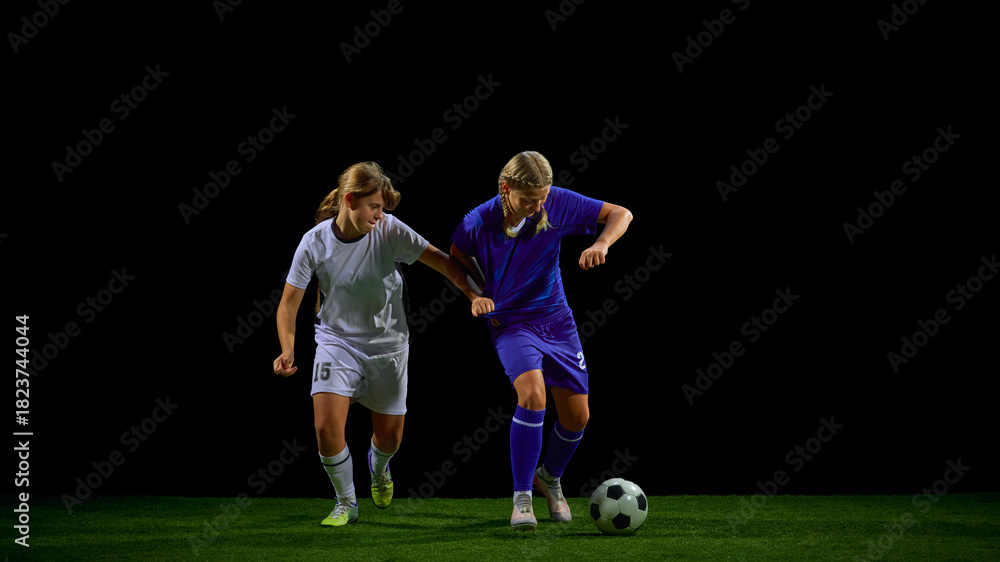 Obraz premium Young soccer players struggling in physical contest for ball. Concept of strength training, contact drills, competitive sport teaching, match intensity analysis.