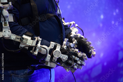 limb exoskeleton worn by man in blue jeans