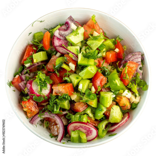 Freshly chopped vegetable salad in a white bowl top view.