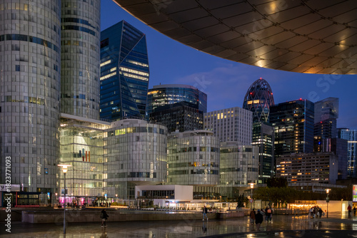 Architecture and skyscraper volumes emerging in Paris where evening reflection accentuates finance and business themes across the urban landscape linked to the corporate district of La Defense.