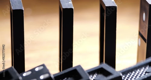 Rows Of Dominoes Falling Sequentially In Chain Reaction Demonstration Close-Up Mechanical Motion Real-Time Domino Effect For Educational Or Entertainment Purpose Sound Included 