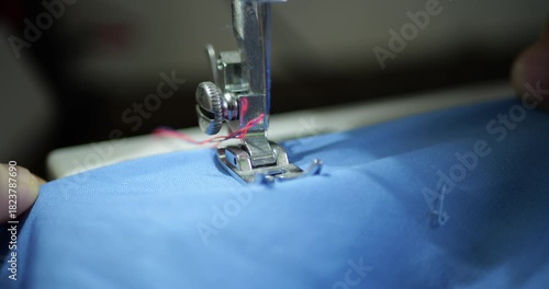 Sewing Machine Close Up Stitching Blue T-shirt. Textile Manufacturing, Mass Production Process. Fashion Business, E-commerce, Marketplace Product, Industrial Work, Fast Fashion Industry