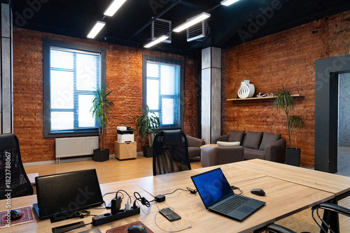 Modern office space with brick walls and stylish furniture for a productive environment