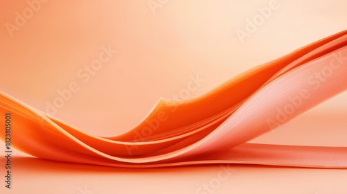 Flowing orange fabric layers curve gently on a soft peach background with smooth lighting.