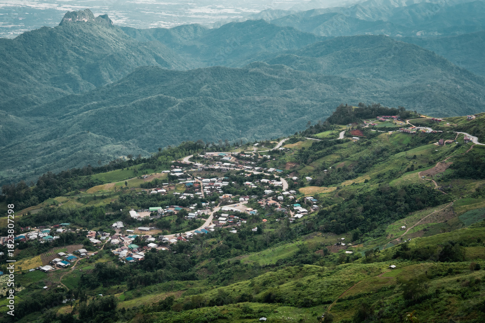 Fototapeta premium Beautiful mountain landscape with sea of mist, winding road, and resorts at Phu Thap Boek, Thailand.