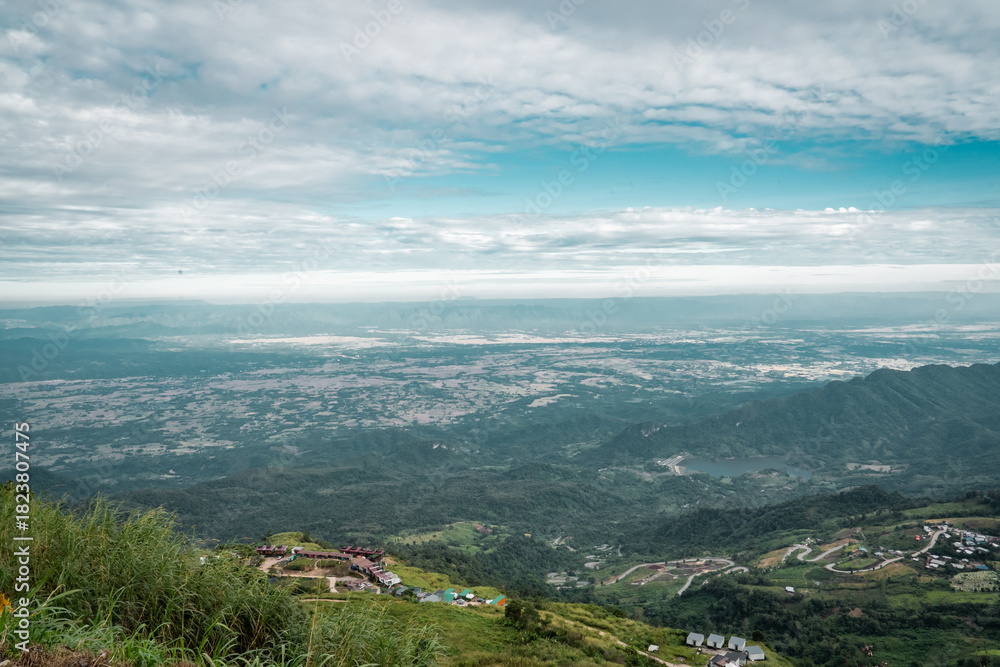 Fototapeta premium Beautiful mountain landscape with sea of mist, winding road, and resorts at Phu Thap Boek, Thailand.