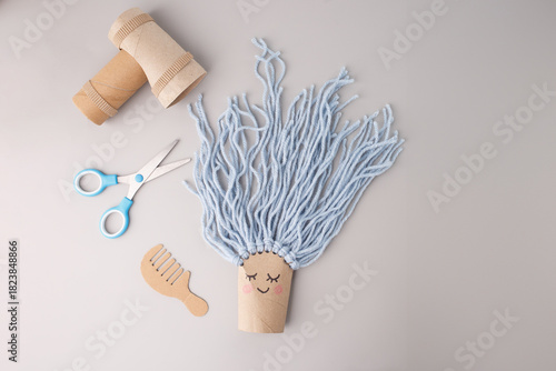 Creative recycled craft with cardboard and yarn, ideal for eco-friendly brands, DIY blogs, educational platforms, toy designers, sustainability campaigns, parenting magazines