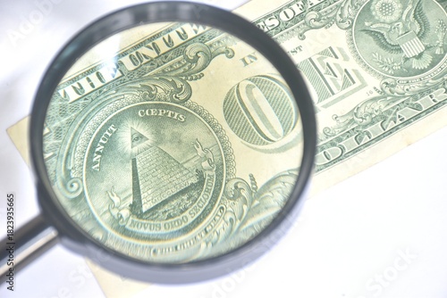 magnifying glass zooming pyramid of one US dollar banknote background and texture